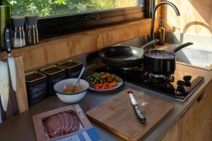 a kitchen counter with a stove and a plate of food at Castor in Abergele