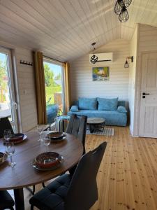 a living room with a table and a blue couch at BananaHouse Junior in Kruszwin
