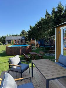 a patio with a table and chairs and a playground at BananaHouse Junior in Kruszwin