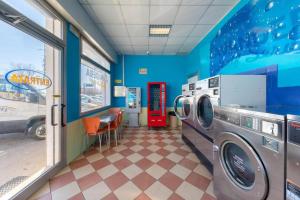 a washer and dryer in a room with a restaurant at Albergo Nuova Aurora - FREE PARKING & BREAKFAST in Marghera