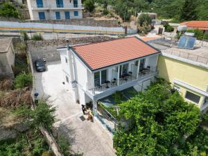an overhead view of a house with a red roof at Irene's rooms in Himare