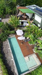 an overhead view of a swimming pool with umbrellas at T3 Moderne avec piscine Oasis de nature et Sérénité in Petit-Canal +4 photos