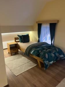 a bedroom with a bed and a window at Tara Saric Duplex in Kaludjerske Bare