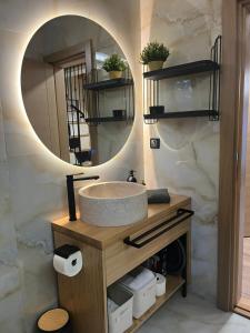 a bathroom with a sink and a mirror at Tara Saric Duplex in Kaludjerske Bare +15 photos
