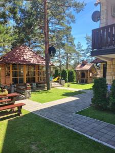 a house with a picnic table and a building at Tara Saric Duplex in Kaludjerske Bare