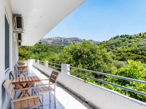 a balcony with chairs and a view of the mountains at Bodini's Rooms in Himare