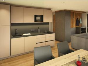 a kitchen with white cabinets and a table with chairs at App. Sun Burdengeja in Selva di Val Gardena