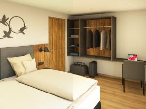 a bedroom with a bed and a closet at App. Sun Burdengeja in Selva di Val Gardena +2 photos