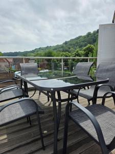 a table and chairs sitting on a deck at Number 1 School Path in Coalbrookdale
