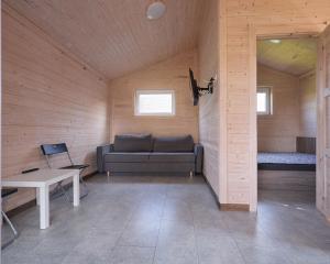 a living room with a couch in a wooden room at Jūros terasos in Šventoji