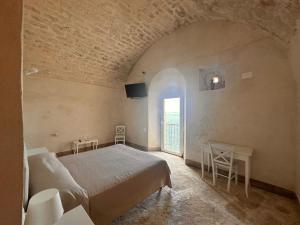 a bedroom with a bed and a window at Rocca Sul Mare Hotel in Vieste