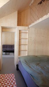 a bedroom with a bunk bed and a couch at Union Lodge Fabrik in Bern +4 photos