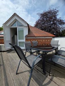 a patio with a table and chairs on a deck at Number 1 School Path in Coalbrookdale