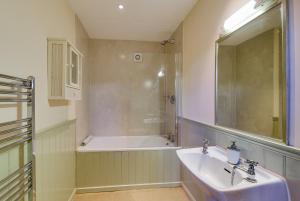 a bathroom with a sink and a bath tub at Trevadlock Manor by Smart Welcomes in Launceston +54 photos