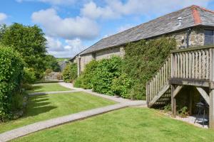 an external view of a stone building with a walkway at Trevadlock Manor by Smart Welcomes in Launceston