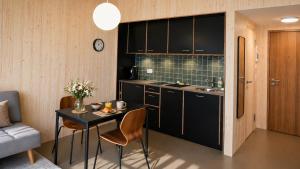 a small kitchen with a table and a couch at Union Lodge Fabrik in Bern