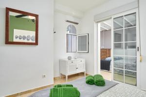 a white room with a bed and a mirror at Casa Trino in Almuñécar +25 photos