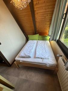 a bed in a small room with a window at Ferienhaus Eichhörnchennest in Waldbrunn +13 photos
