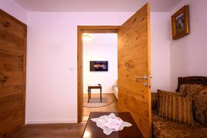 a room with a door and a table and a chair at Gegë Boutique Hotel in Gjakove