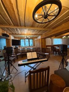 a room with a piano and tables and chairs at Noclegi Pod Muńcołem in Ujsoły