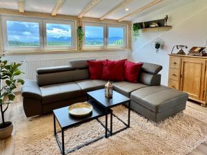 a living room with a couch and a table at LuxLife - Panorama Bergblick, Sauna, Balkon, Luxus Pur in Buchenberg