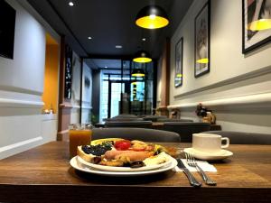 a plate of food on a table in a restaurant at Old Money Boutique Hotel in Baku