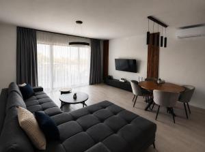 a living room with a couch and a table at Blue Breeze in Sinemorets
