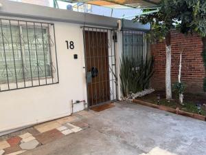 a front door of a house with a gate at Casa Cholula in La Concepción