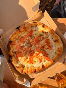 a pizza in a box on a table at Mountain View in Vyshkove