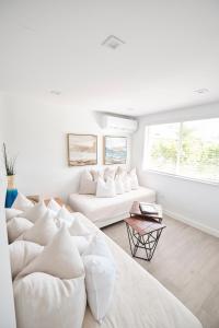 a white living room with a large white couch at Waterfront Cabana 2 Key Largo in Key Largo