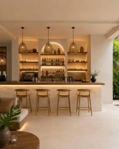a bar in a villa with bar stools at Maxx Una in Unawatuna