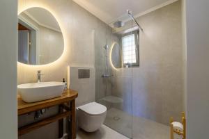a bathroom with a sink and a toilet and a shower at Orange House - Upper East apartment in Promírion