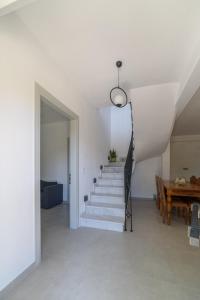 a staircase in a living room with a table at Orange House - Upper East apartment in Promírion