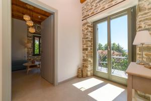 a living room with a large window and a table at Orange House - Upper East apartment in Promírion