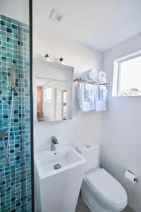 a bathroom with a toilet and a sink and a mirror at Waterfront Cabana 2 Key Largo in Key Largo +31 photos