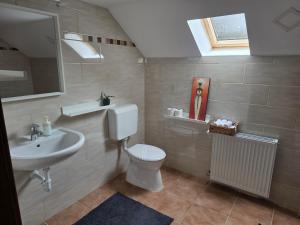 a bathroom with a toilet and a sink at Határ Motel in Somoskőújfalu +47 photos