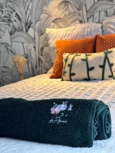 a bed with a black blanket on it with graffiti at Villa Tchama in Salazie