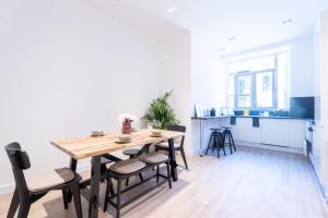 a kitchen and dining room with a wooden table and chairs at Maison Rouget - Chambre 1 - Mimosa in Nice