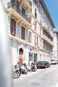 a group of motorcycles parked in front of a building at Maison Rouget - Chambre 1 - Mimosa in Nice