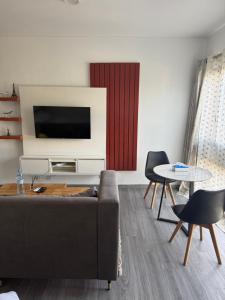 a living room with a couch and a tv at Harmonie in Abidjan