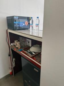 a room with a counter with two bottles of water at Harmonie in Abidjan