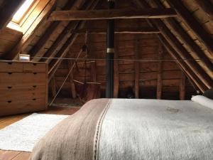 a bedroom with a bed in a attic at Cabaña Vento Norte in Vilamós +5 photos