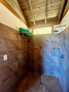a bathroom with a shower with a glass shower stall at REFUGIO el CAMPANO in Minca +23 photos
