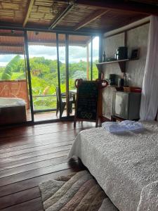 a bedroom with a bed and a table and windows at Hotel Cabañas Del Quindio in Filandia +147 photos