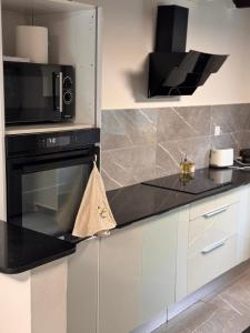 a kitchen with a microwave and a stove at Villa Tchama in Salazie