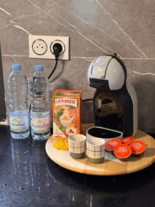 a coffee maker and two bottles of water on a counter at Villa Tchama in Salazie