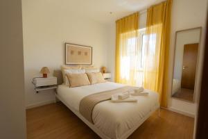 a bedroom with a bed with two towels on it at BV 01 Apartment in Amadora