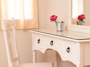 a white dressing table with a mirror and roses on it at 9 Muses in Andros +43 photos
