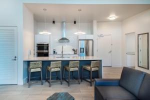 a kitchen with a blue island with bar stools at Max Beach Resort in Daytona Beach