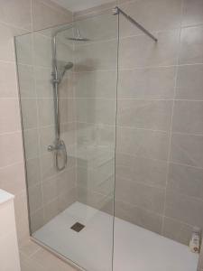 eine Dusche mit Glastür im Badezimmer in der Unterkunft Teniente Bago con opción de aparcamiento in Jaén
